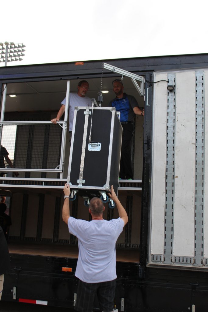 Tuba Lift on North Mesquite High School Semi Trailer with a security gate and fence