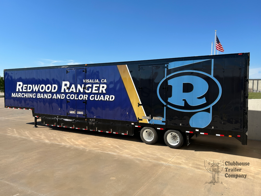 Redwood High school custom marching band trailer with blue, gold, and black vinyl wrap.