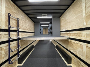 Interior of a small trailer solution, completed with a second floor, ship's ladder for second level access, instrument storage, and drum wall.