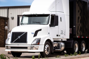 Clubhouse Logistics Company sleeper volvo tractor, moving semi marching band trailer.