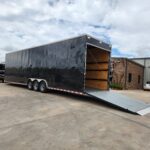 Black turn-key bumper pull marching band trailer with rear ramp