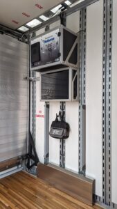 Clubhouse marching band semi interior with full width ramp and battery cabinet for solar power