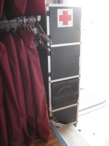 On this side of the Electrical Cabinet is a first aid cabinet, tool storage cabinet, and fuse panel.