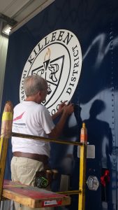 Killeen ISD Seal on Band Semi Trailers being applied to Shoemaker Band Trailer